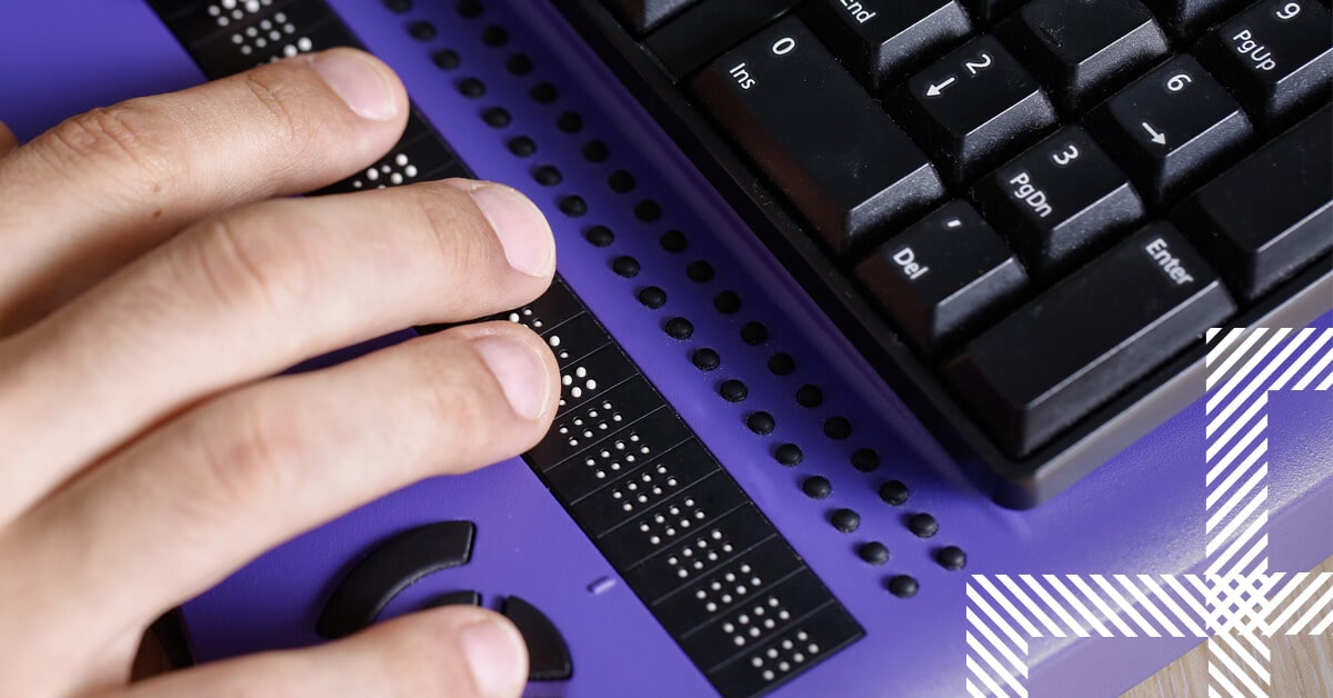 Person uses computer with braille computer display